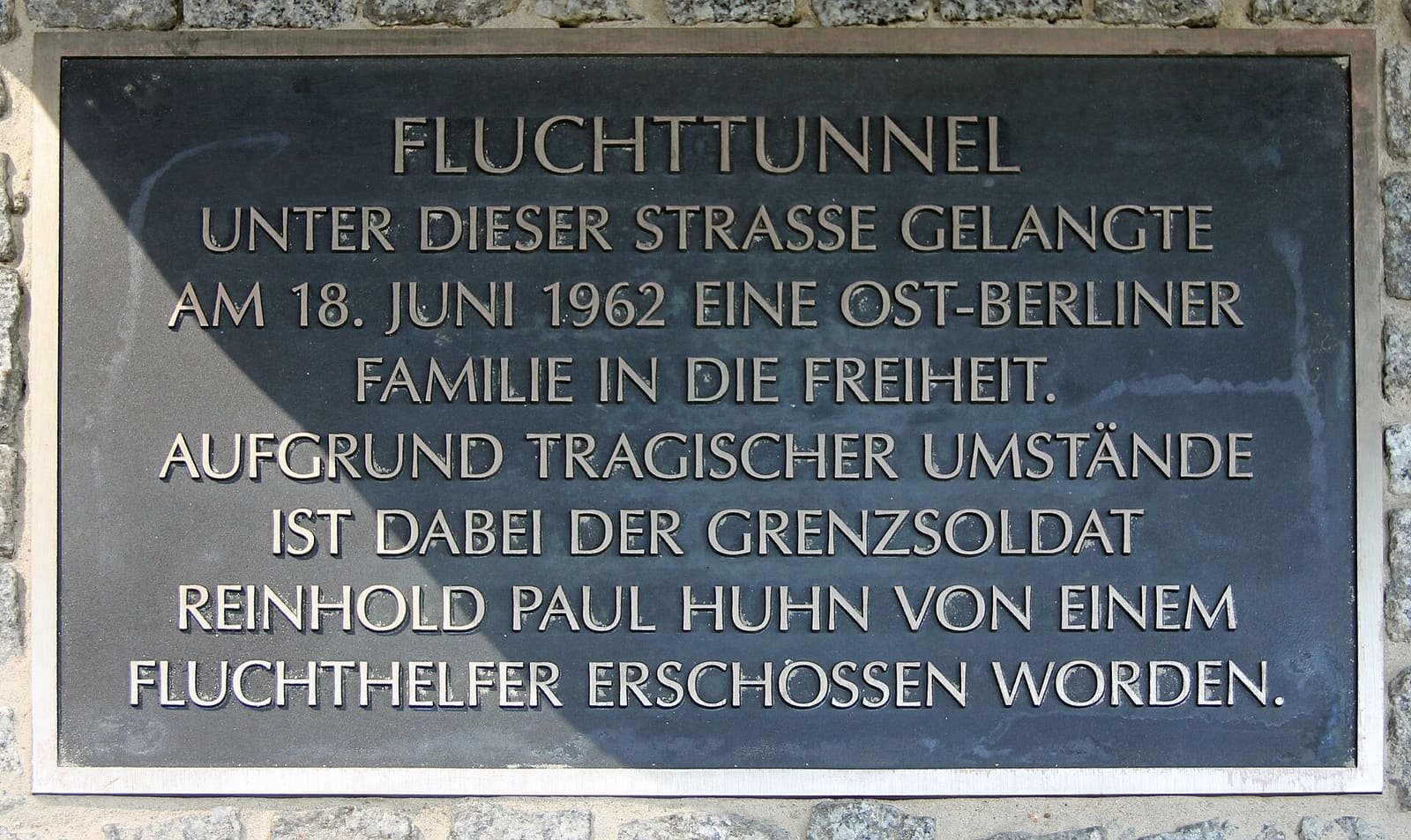 Bronze plaque headed 'Fluchttunnel' set into the pavement