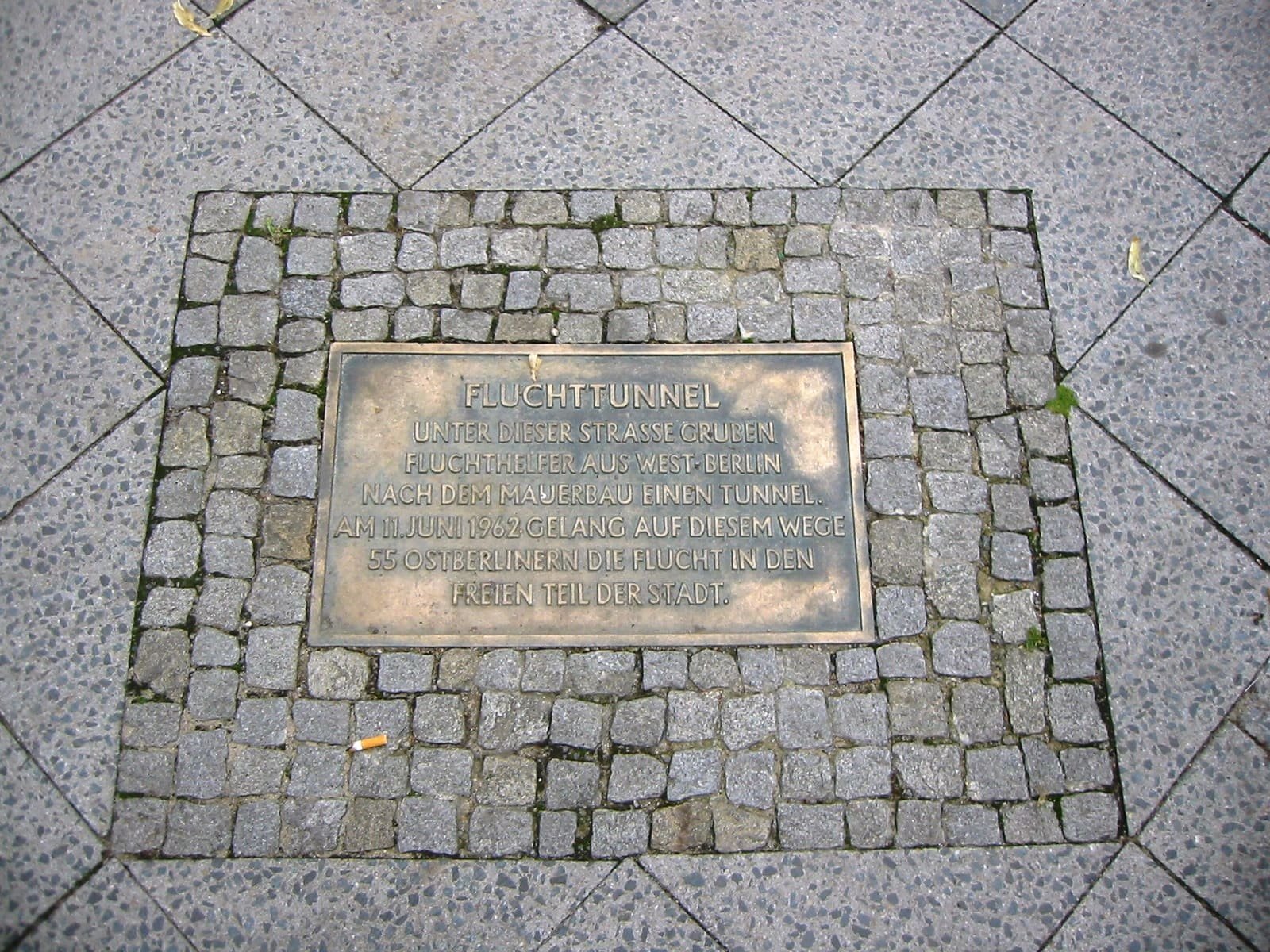 Small metal plaque set into paving stones