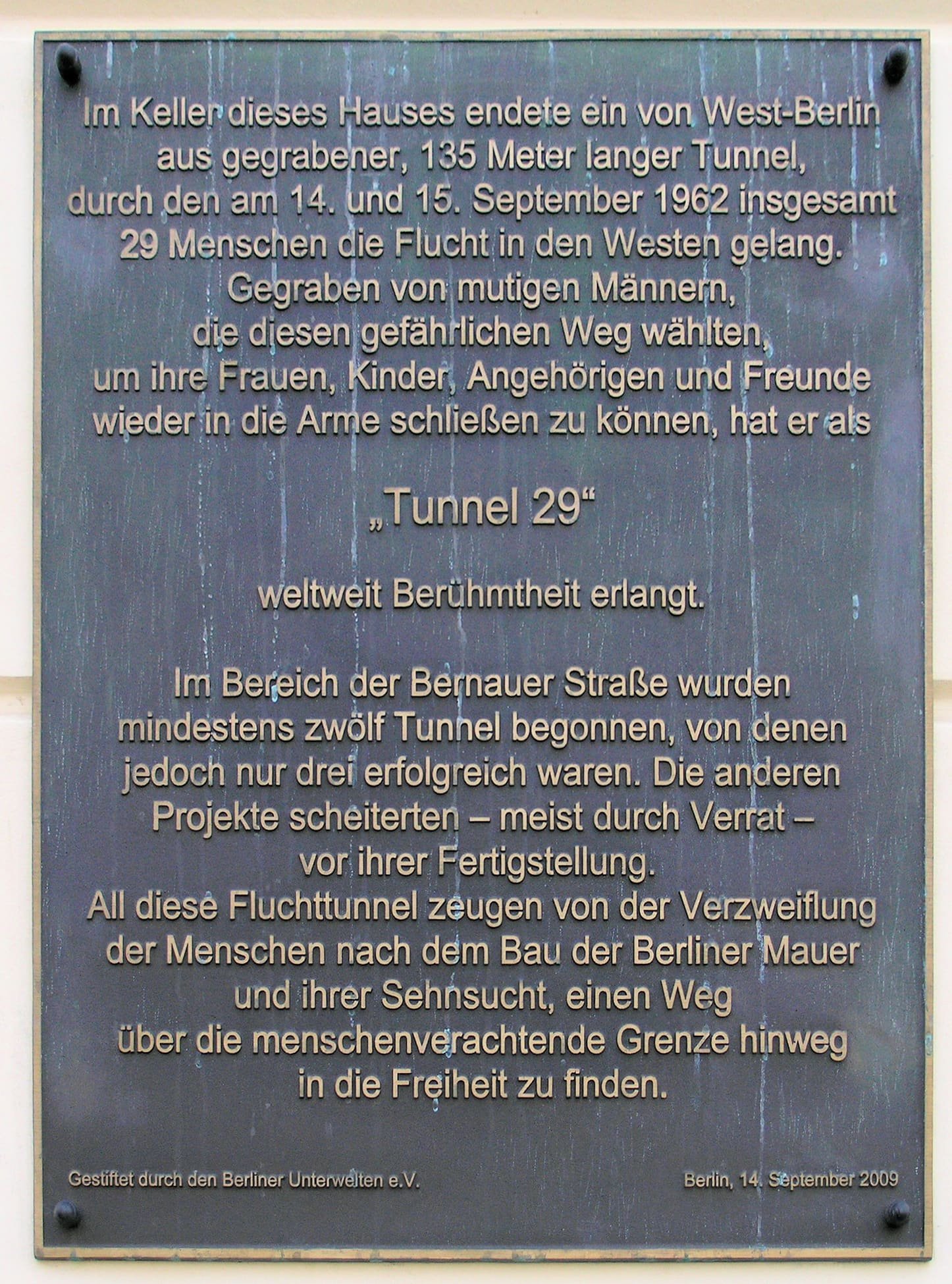 A plaque on a house wall with text about Tunnel 29.