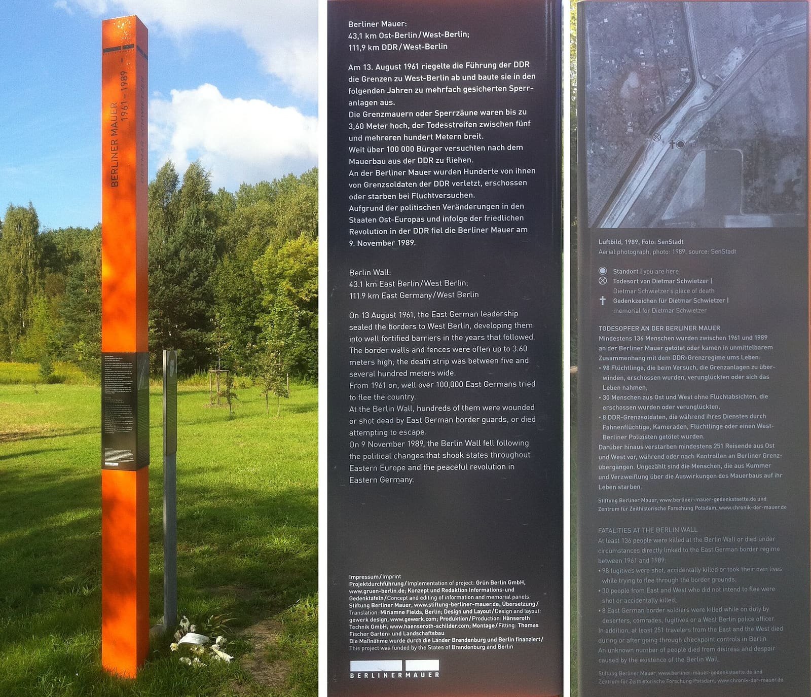 A rust-coloured memorial stele with a portrait and text panel at the edge of fields and woodland