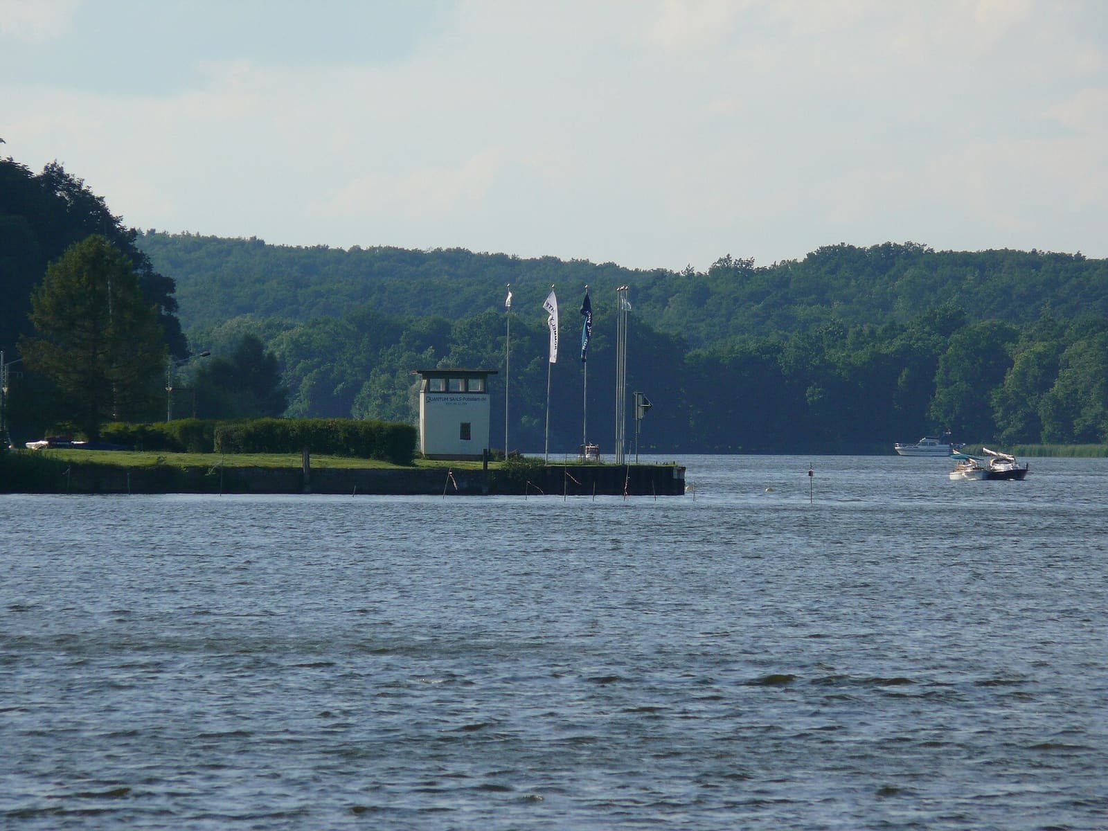 A former East German concrete border watchtower standing by the shore of the Jungfernsee.