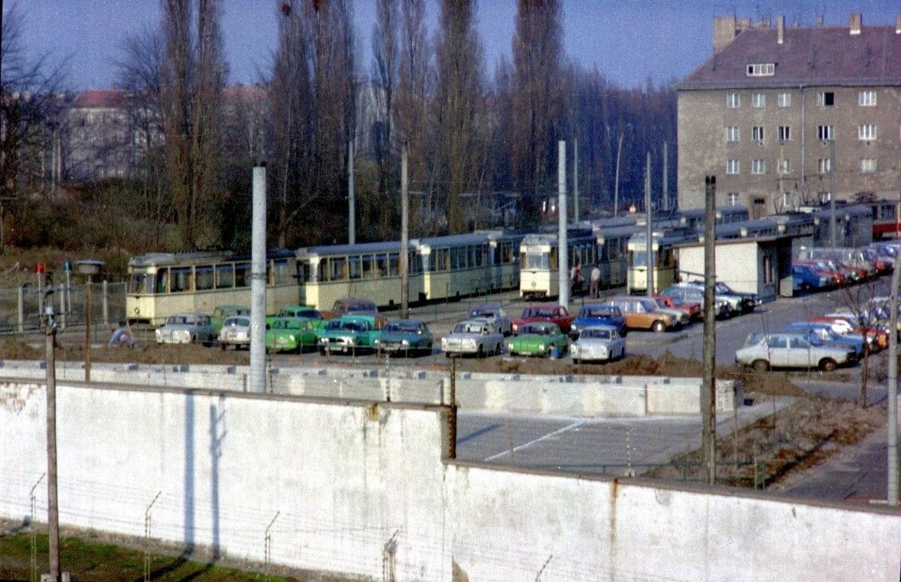 View across the Wall towards an East Berlin street with a tram turning loop