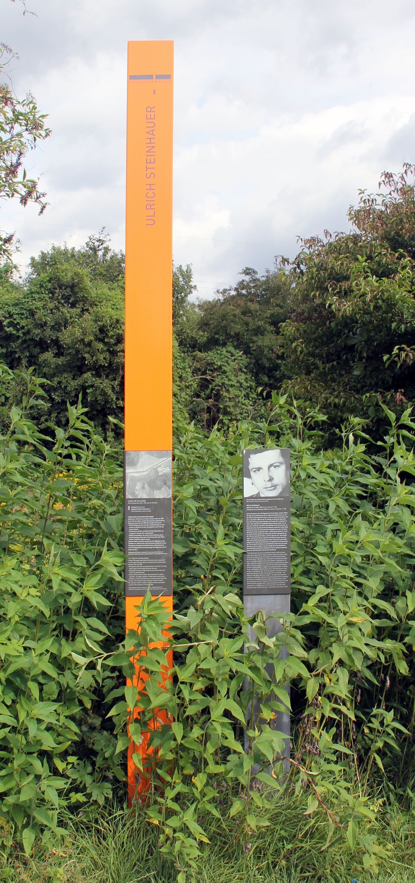 A tall narrow memorial panel with text about Ulrich Steinhauer