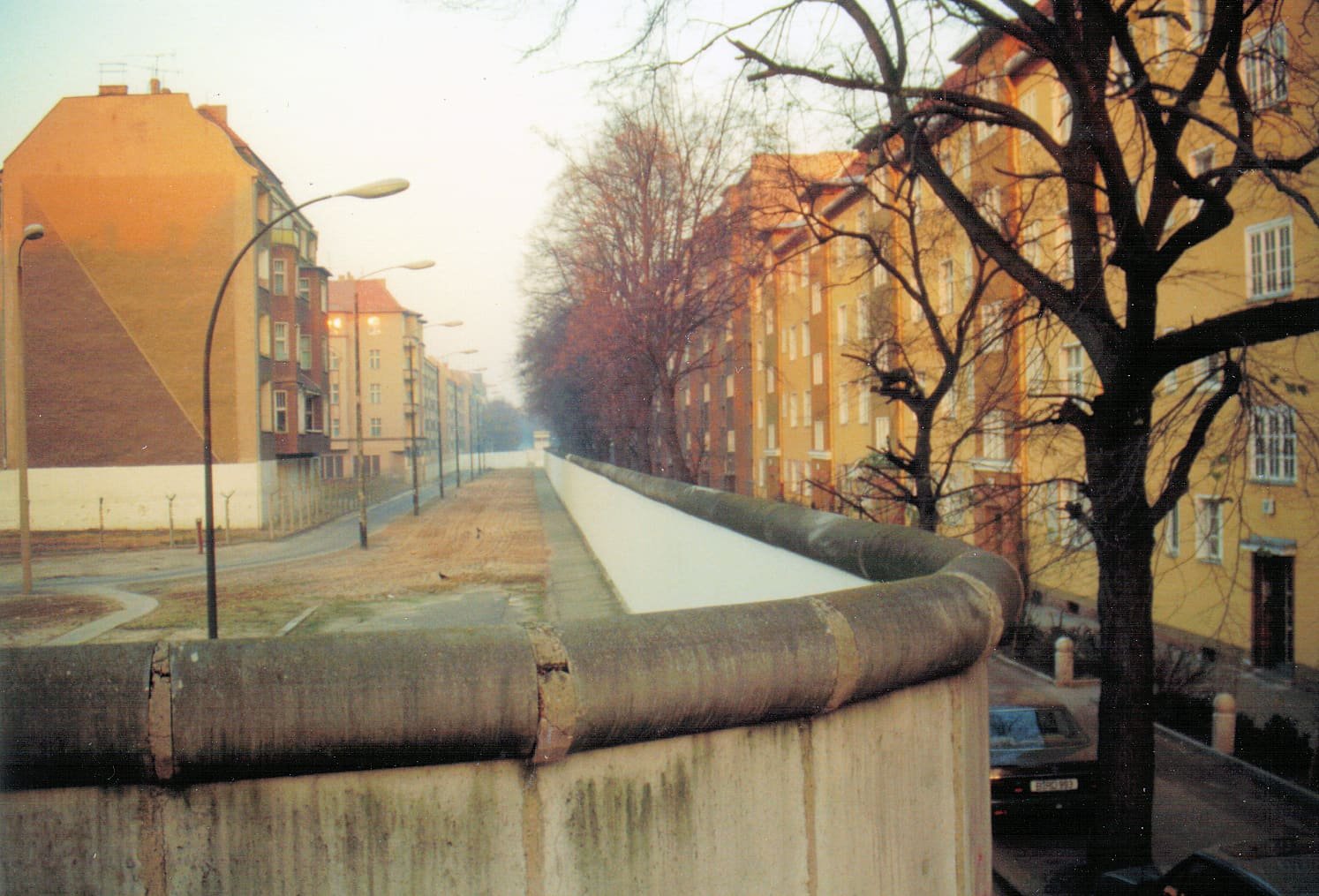 The Berlin Wall running along a street corner in Treptow, November 1989.