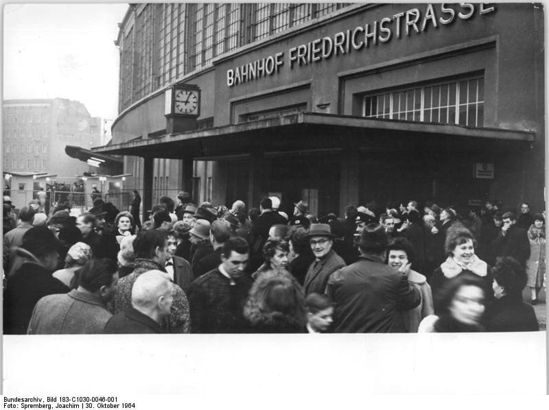 Historical photograph of people at the border checkpoint inside Friedrichstraße station