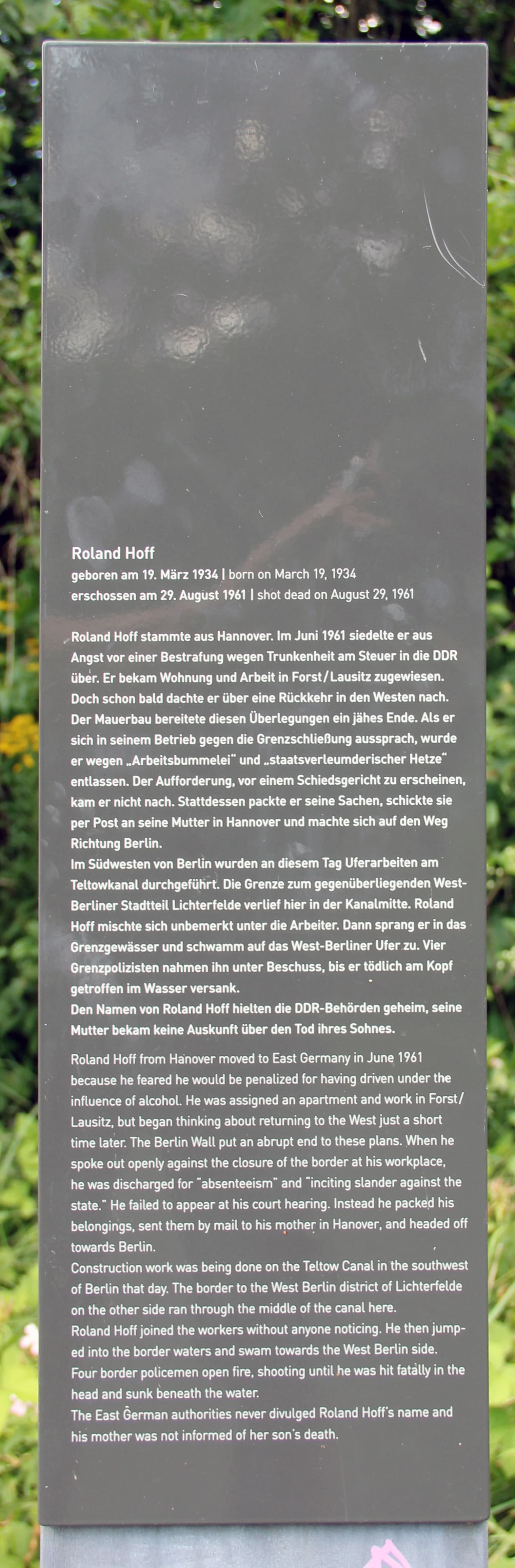 An upright memorial plaque with text commemorating Roland Hoff.