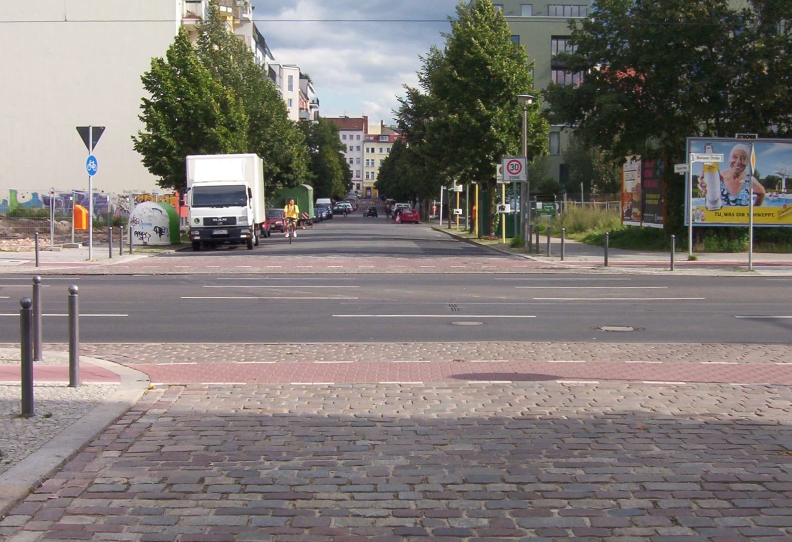A street junction beside a grassy former border strip