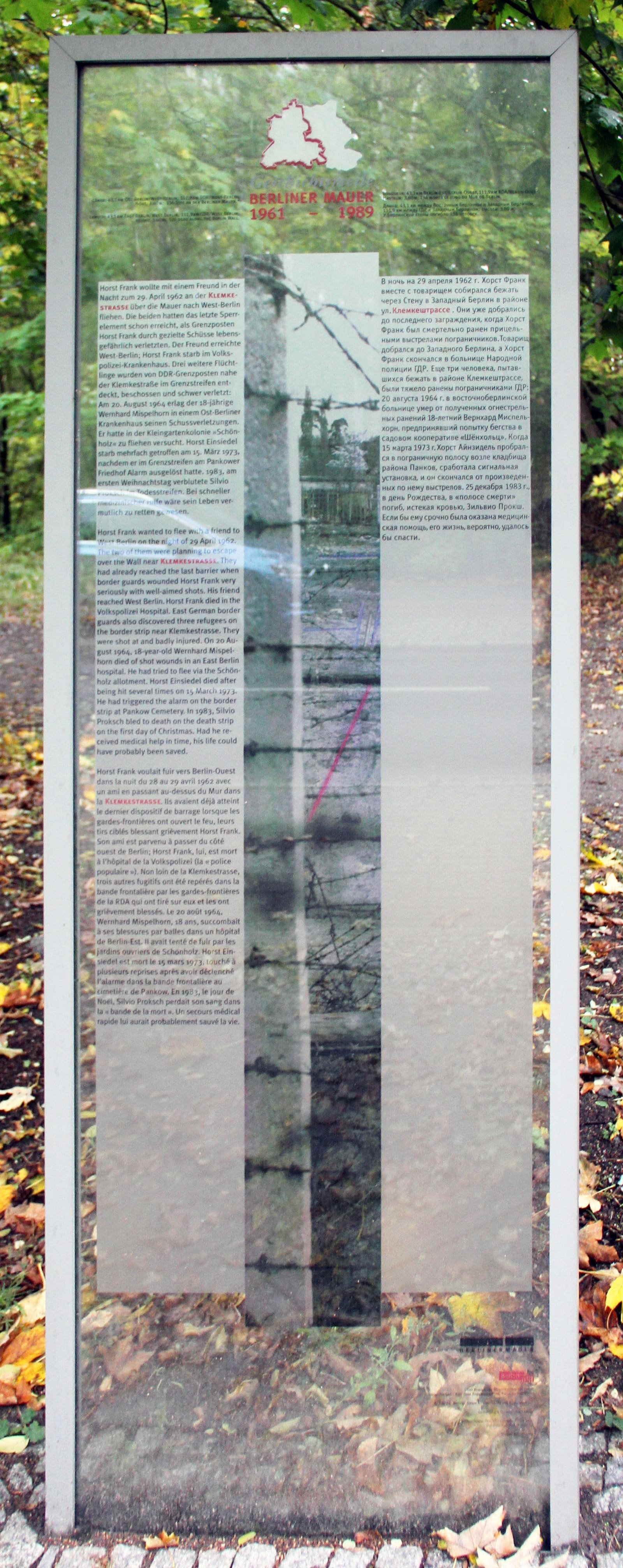A tall memorial panel with the names and stories of four people killed at the Berlin Wall